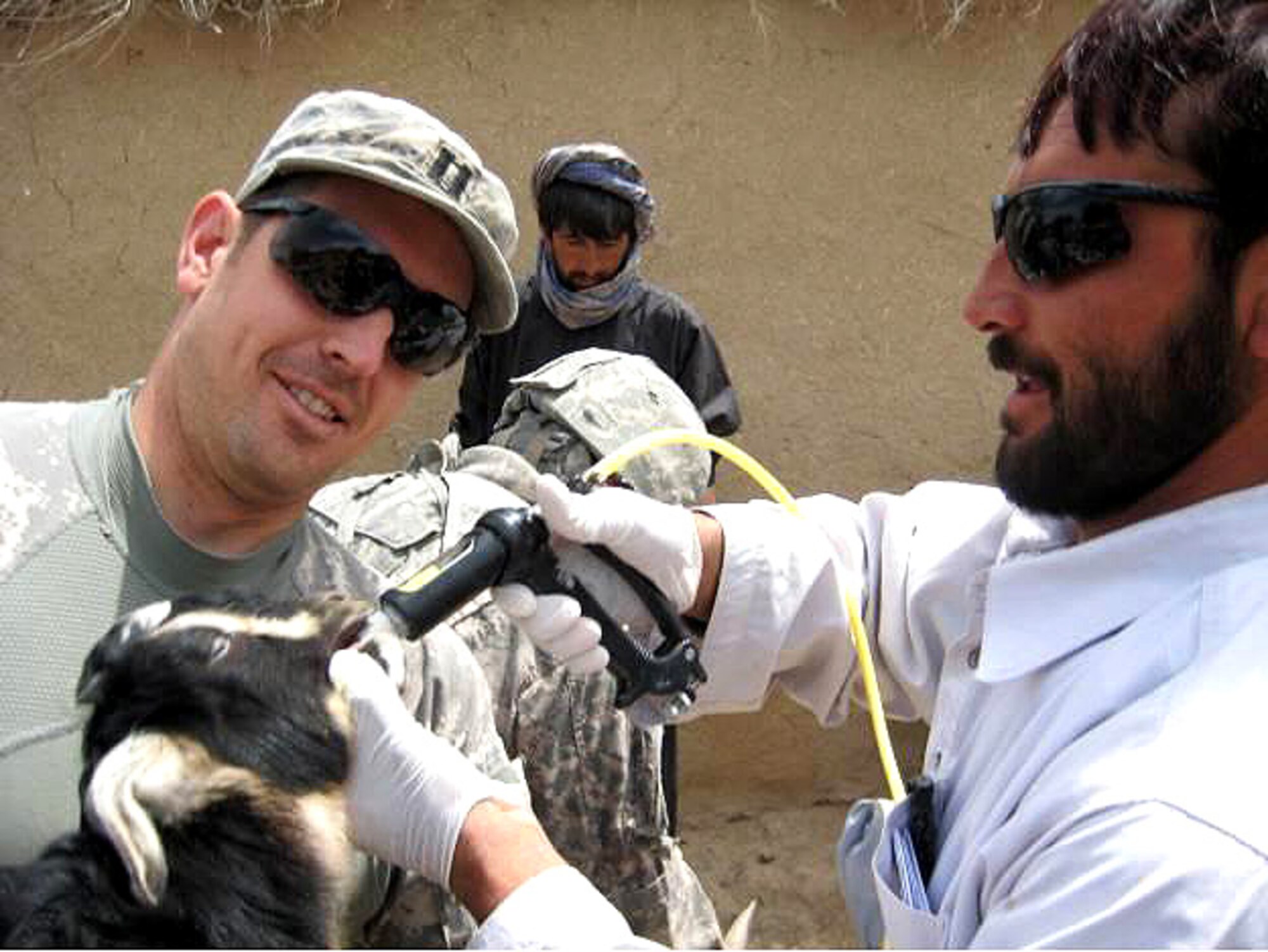 Air Force Capt. (Dr.) William Errico assists a local Afghan para vet provide de-worming medicine. Doctor Errico along with members of the Zabul Provincial Reconstruction Team, Embedded Training Team, Army veterinarians, and Afghan para vets traveled to outlying districts of Zabul Province to treat over 1,500 animals for worms and other infections. (Air Force/Staff Sgt. Warren Williamson)