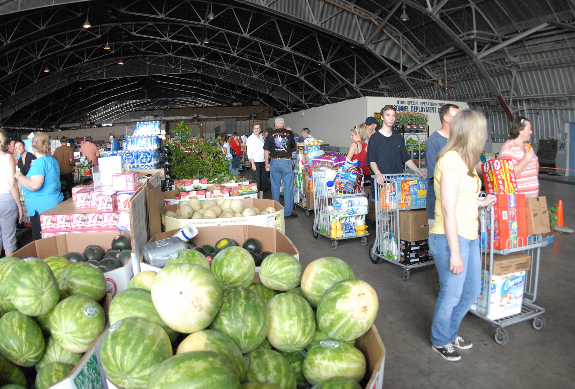 Once inside the hangar, the line snaked around with lots surrounding customers from fruits to detergents at the case lot sale at Duke Field May 2.  People began lining up early, braved the heat of the day, and long wait to get the deals available from the sale.  U.S. Air Force photo/Staff Sgt. Samuel King Jr.