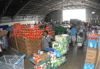 Once inside the hangar, the line snaked around with lots surrounding customers from fruits to detergents at the case lot sale at Duke Field May 2.  People began lining up early, braved the heat of the day, and long wait to get the deals available from the sale.  U.S. Air Force photo/Staff Sgt. Samuel King Jr.