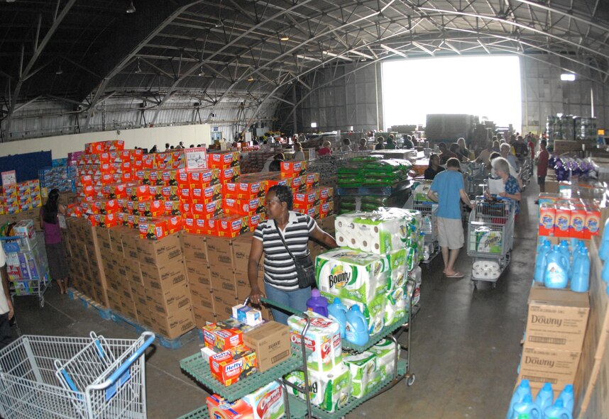 Once inside the hangar, the line snaked around with lots surrounding customers from fruits to detergents at the case lot sale at Duke Field May 2.  People began lining up early, braved the heat of the day, and long wait to get the deals available from the sale.  U.S. Air Force photo/Staff Sgt. Samuel King Jr.