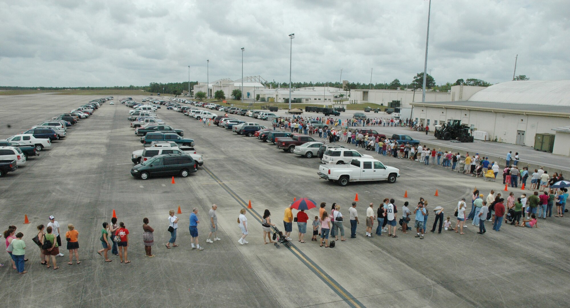 The line to enter the case lot sale extended out from the building and onto the taxiway and parking lot May 2 at Duke Field.  People began lining up early, braved the heat of the day, and long wait to get the deals available from the sale.  U.S. Air Force photo/Staff Sgt. Jon McCallum.