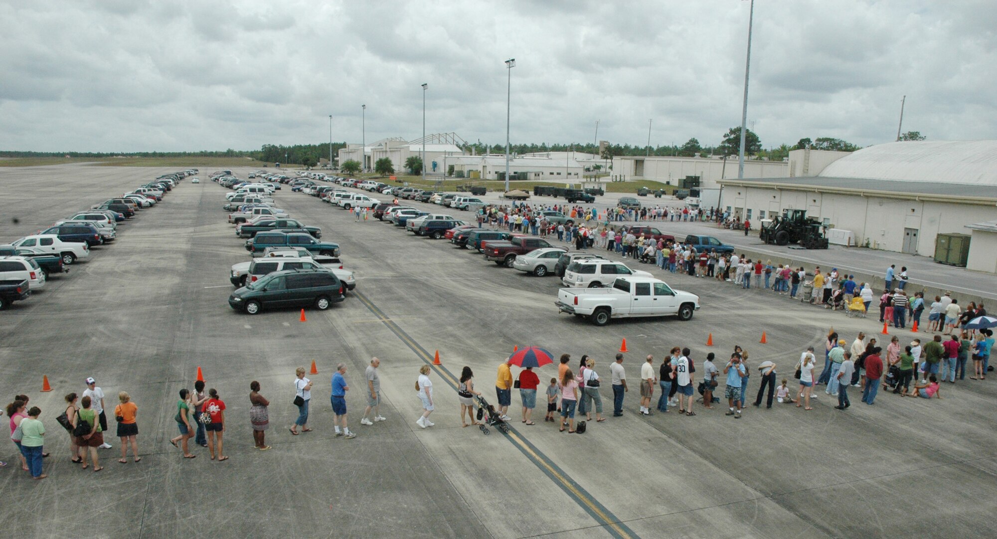 The line to enter the case lot sale extended out from the building and onto the taxiway and parking lot May 2 at Duke Field.  People began lining up early, braved the heat of the day, and long wait to get the deals available from the sale.  U.S. Air Force photo/Staff Sgt. Jon McCallum.