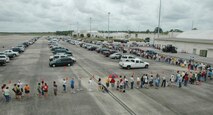 The line to enter the case lot sale extended out from the building and onto the taxiway and parking lot May 2 at Duke Field.  People began lining up early, braved the heat of the day, and long wait to get the deals available from the sale.  U.S. Air Force photo/Staff Sgt. Jon McCallum.