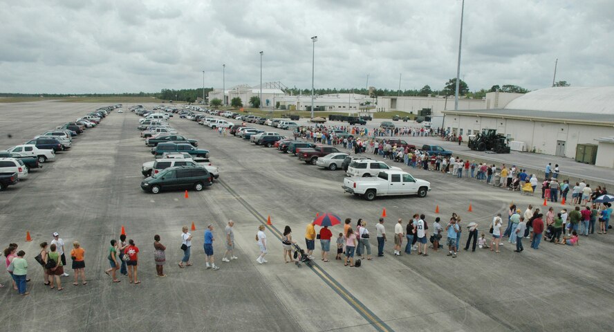 The line to enter the case lot sale extended out from the building and onto the taxiway and parking lot May 2 at Duke Field.  People began lining up early, braved the heat of the day, and long wait to get the deals available from the sale.  U.S. Air Force photo/Staff Sgt. Jon McCallum.