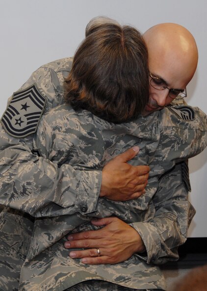 Newly promoted Chief Master Sgt. Michael Klausutis, hugs his wife Senior Master Sgt. Delores Klausutis, 919th Communications Squadron, after his Chief induction ceremony at Duke Field May 2.  As well as being the 919th Special Operations Wing’s newest chief master sergeant, Chief Klausutis also became its newest command chief as well.  U.S. Air Force photo/Staff Sgt. Samuel King Jr.