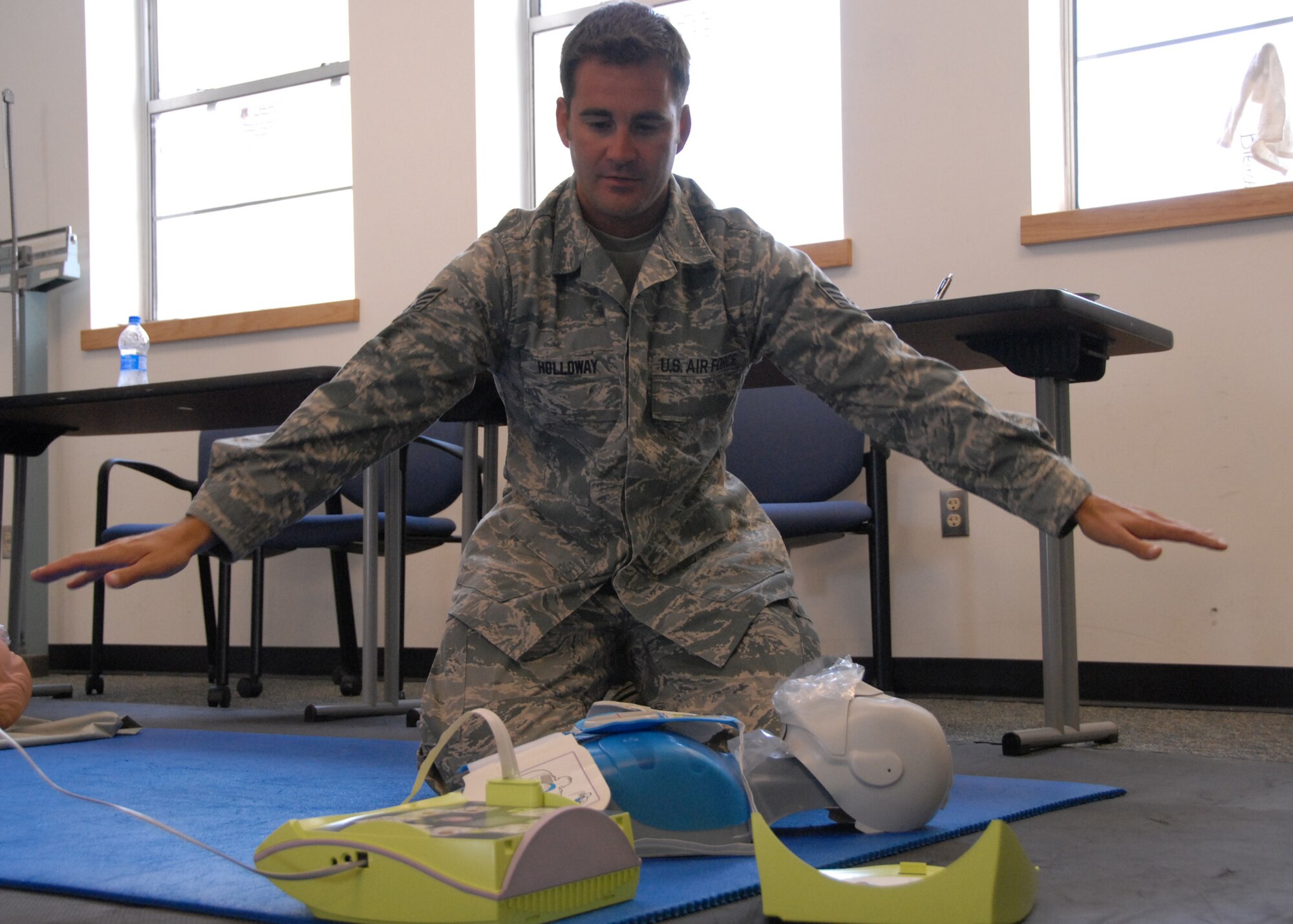 Staff Sgt. Jeff Holloway clears the area around the victim before the defibrillator simulates a shock at CPR class held May 3 at Duke Field.  Three other 919th Special Operations Wing members were trained over the UTA weekend.  (U.S. Air Force photo/Staff Sgt. Samuel King Jr.)