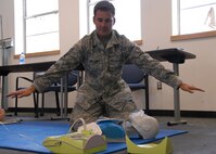 Staff Sgt. Jeff Holloway clears the area around the victim before the defibrillator simulates a shock at CPR class held May 3 at Duke Field.  Three other 919th Special Operations Wing members were trained over the UTA weekend.  (U.S. Air Force photo/Staff Sgt. Samuel King Jr.)