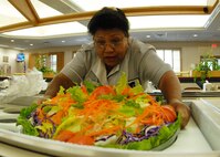 A dining facility employee places the large salad bowl into the salad bar while prepping for lunch May 3 at Duke Field.  The 919th SVF won a Hennessy Award this year for their superior performance at the dining facility.  U.S. Air Force photo/Staff Sgt. Samuel King Jr.