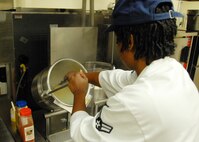 Airman 1st Class Erica Jones, 919th Services Flight, stirs a broth in preparation for the lunch May 3 at the Duke Field dining facility.  The 919th SVF won a Hennessy Award this year for their superior performance at the dining facility.  U.S. Air Force photo/Staff Sgt. Samuel King Jr.