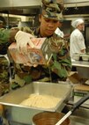 Senior Airman Brittnie Lewis, 919th Services Flight, pours some oil into a breading mix before the lunch May 3 at the Duke Field dining facility.  The 919th SVF won a Hennessy Award this year for their superior performance at the dining facility.  U.S. Air Force photo/Staff Sgt. Samuel King Jr.