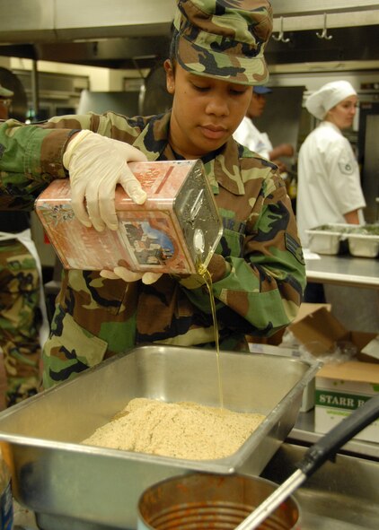Senior Airman Brittnie Lewis, 919th Services Flight, pours some oil into a breading mix before the lunch May 3 at the Duke Field dining facility.  The 919th SVF won a Hennessy Award this year for their superior performance at the dining facility.  U.S. Air Force photo/Staff Sgt. Samuel King Jr.