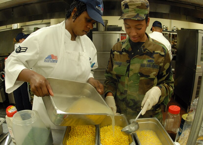 Airman 1st Class Erica Jones helps Senior Airman Anita Pagan 919th Services Flight, prepare the corn for lunch May 3 at the Duke Field dining facility.  The 919th SVF won a Hennessy Award this year for their superior performance at the dining facility.  U.S. Air Force photo/Staff Sgt. Samuel King Jr.