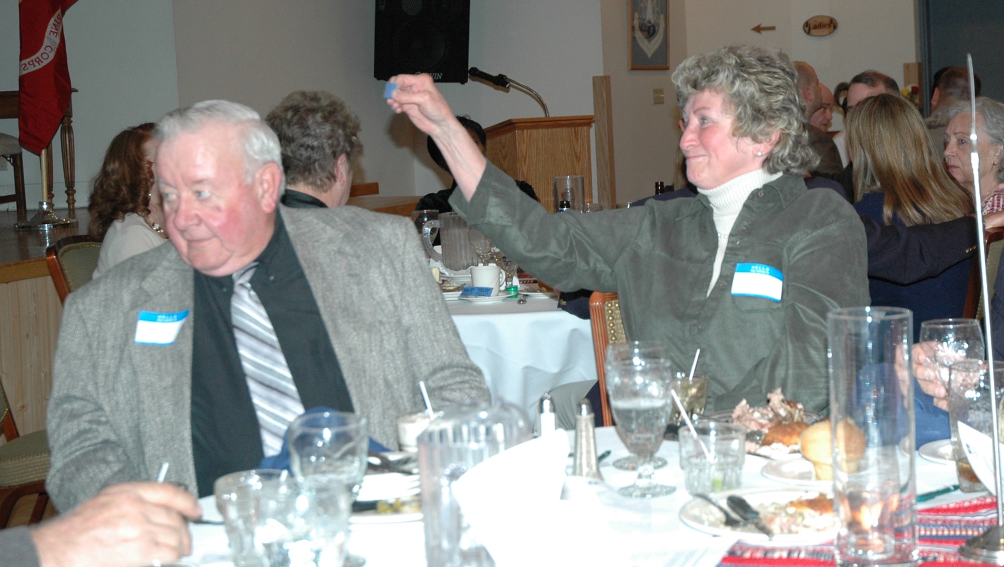 A raffle drawing winner holds up her ticket to claim her prize during the Retiree Appreciation dinner April 25 at the Grizzly Bend Club. (U.S. Air Force photo/Valerie Mullett)
