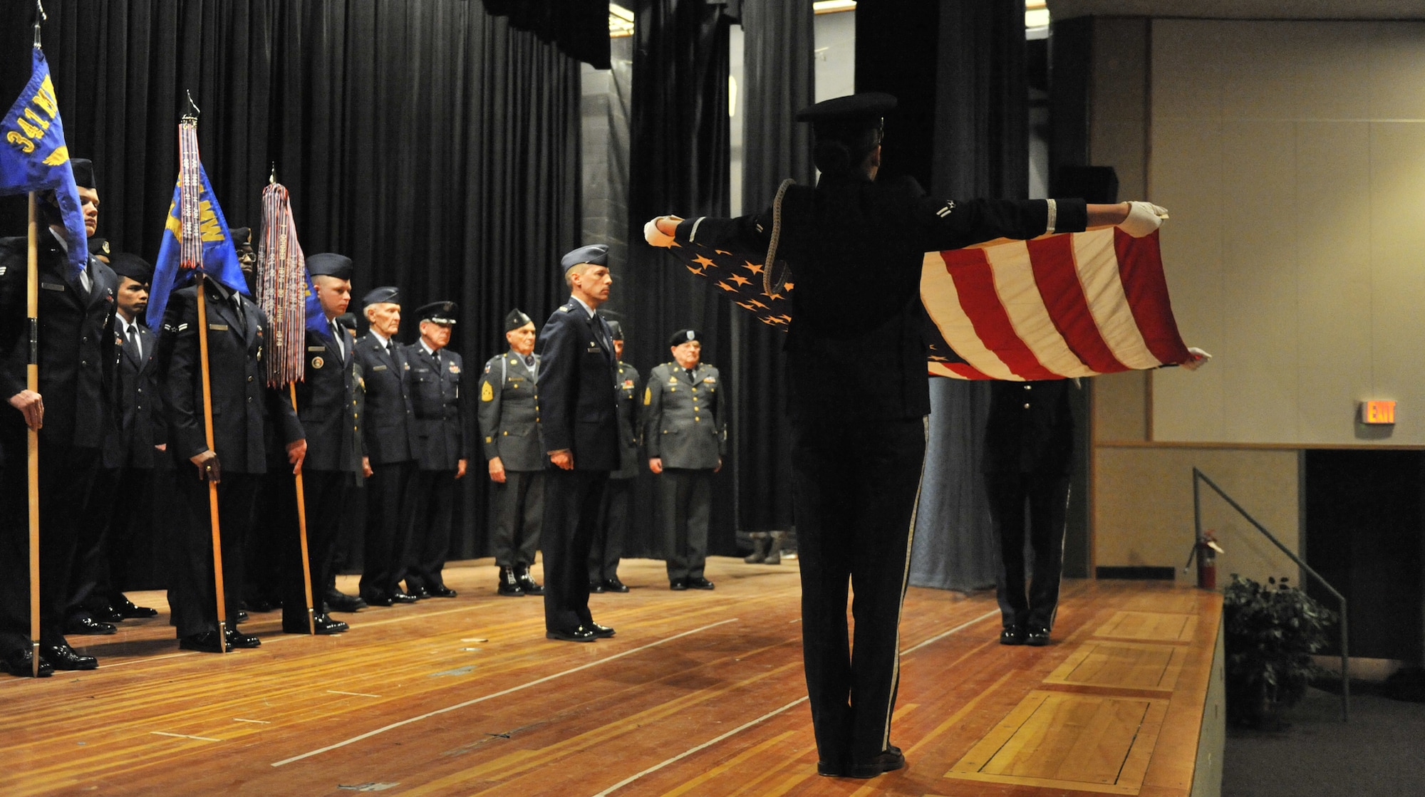 Members of the Malmstrom Honor Guard prepare to fold the flag during a formal retreat ceremony April 24 at the base theater. Col. Roderick Davis (center), 341st Mission Support Group commander presided as the Commander of Troops for the ceremony. Several retirees donned their uniforms to participate in the retreat. (U.S. Air Force photo/John Turner)