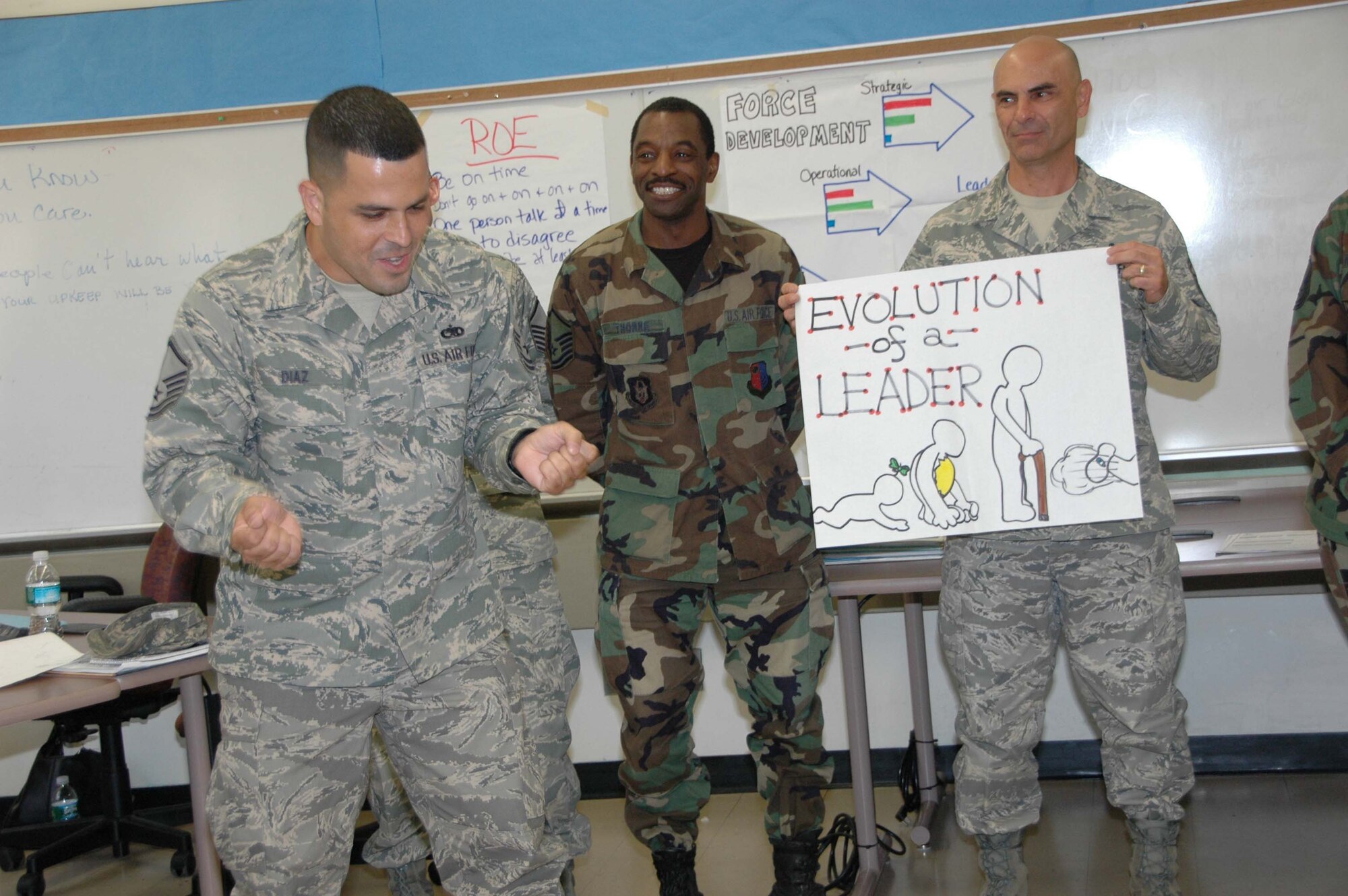 MCGUIRE AIR FORCE BASE, N.J. -- Reservist Master Sgt. Hernan Diaz, left, explains his group's depiction of their learning experience in the weekend-long Senior NCO Leadership Development Course, held here for the first time in April. Members of his group, Master Sgt. Rodric Thorne and Senior Master Sgt. Louis Tortu, both of the 35th  Aerial Port Squadron, look on. The Air Force Reserve Command course provides SNCOs the chance to explore in-depth communications, trust, teamwork and leadership issues and initiatives. (U.S. Air Force Photo/Staff Sgt. Monica L. Dalberg)
