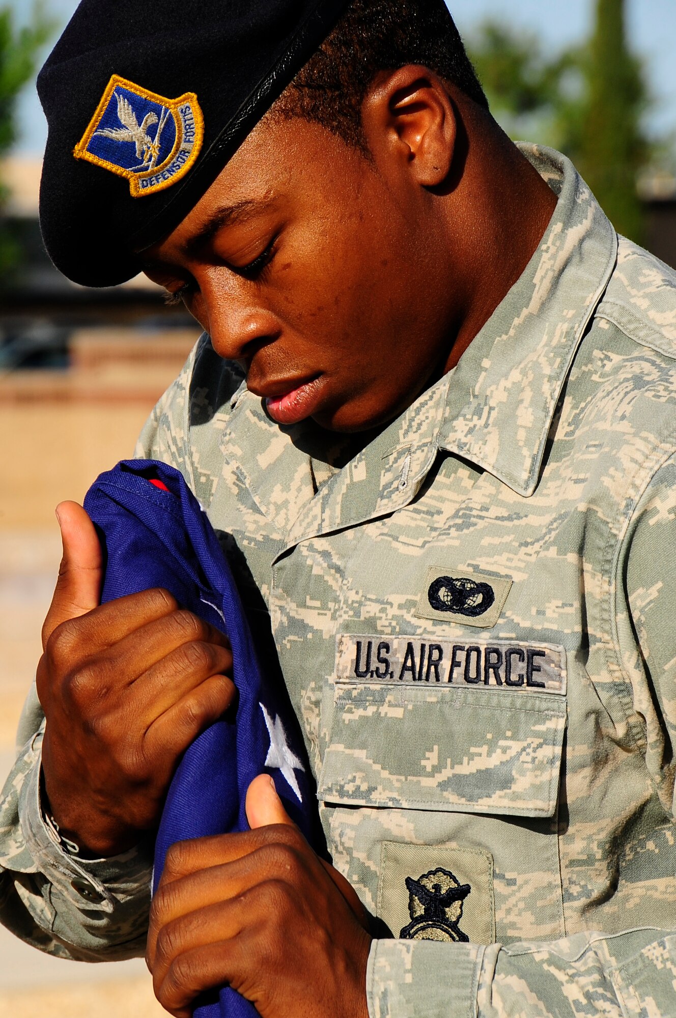 Staff Sgt. Rufus Watson, 49th Security Forces Squadron K-9 handler trainer, folds the American flag during a memorial service May 1 honoring Uro, a Military Working Dog, who died April 24 at Holloman Air Force Base, N.M. (U.S. Air Force photo/Tech. Sgt. Chris Flahive)