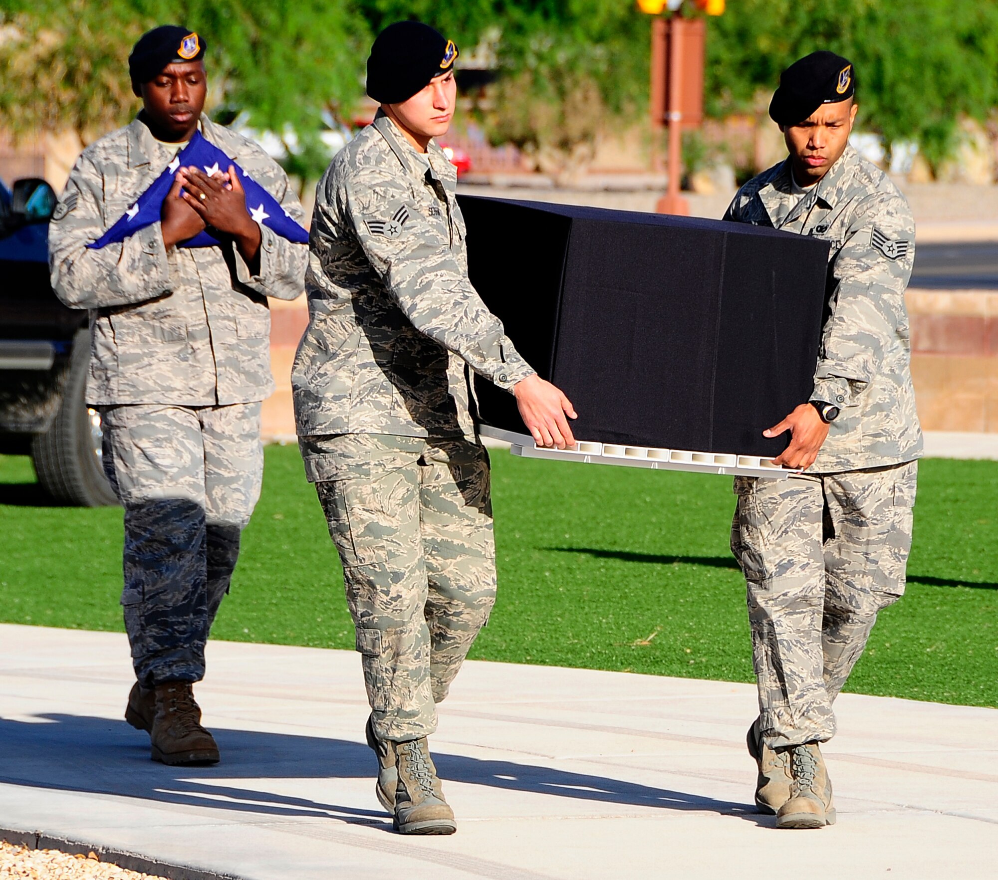 Staff Sgt. Rufus Watson, 49th Security Forces Squadron K-9 trainer, carries the American Flag while Senior Airman Joseph Serrano and Staff Sgt. Daniel Flores, 49th Security Forces K-9 handlers/patrolmen, serve as pallbearers for Uro, a four year-old German Shepherd Military Working Dog. The memorial service took place May 1 at Holloman Air Force Base, N.M. Uro died April 24 from gastric dilatation volvulus. (U.S. Air Force photo/Tech. Sgt. Chris Flahive)