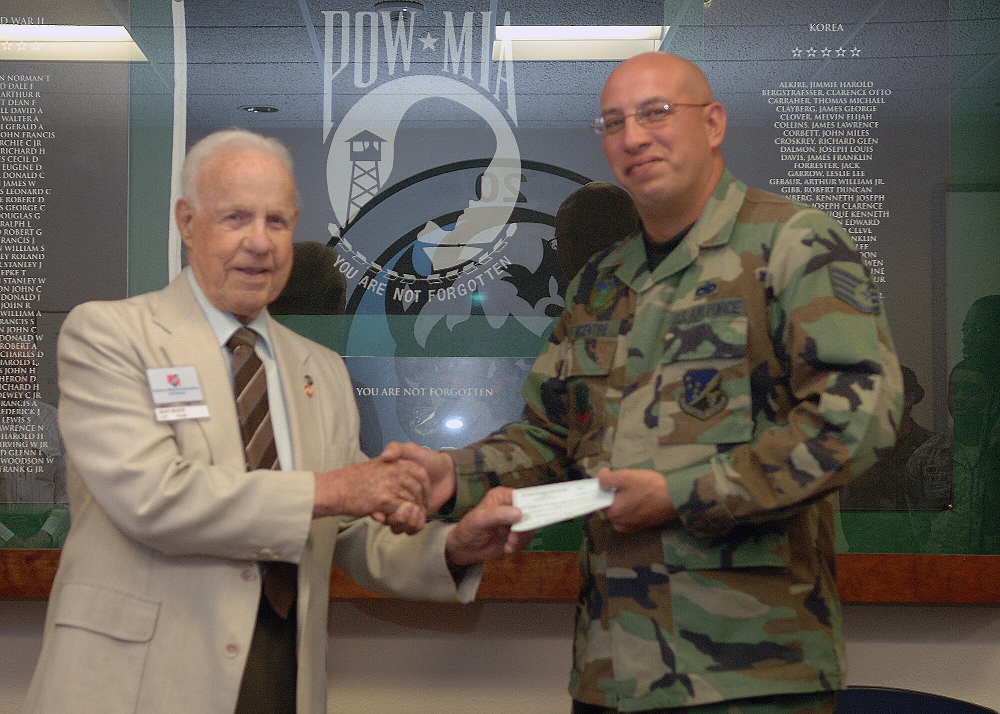 Staff Sgt. Larry McEntire, 49th Maintenance Squadron and president of the Steel Talon Booster Club, receives a $500 check April 24 from the Military Officers Association of America. The check is a part of an annual contribution to the Steel Talons Honor Guard at Holloman Air Force base, N.M. The booster club will use this check to cover operational support expenses throughout the year. (U.S. Air Force photo/Airman 1st Class Veronica Stamps)