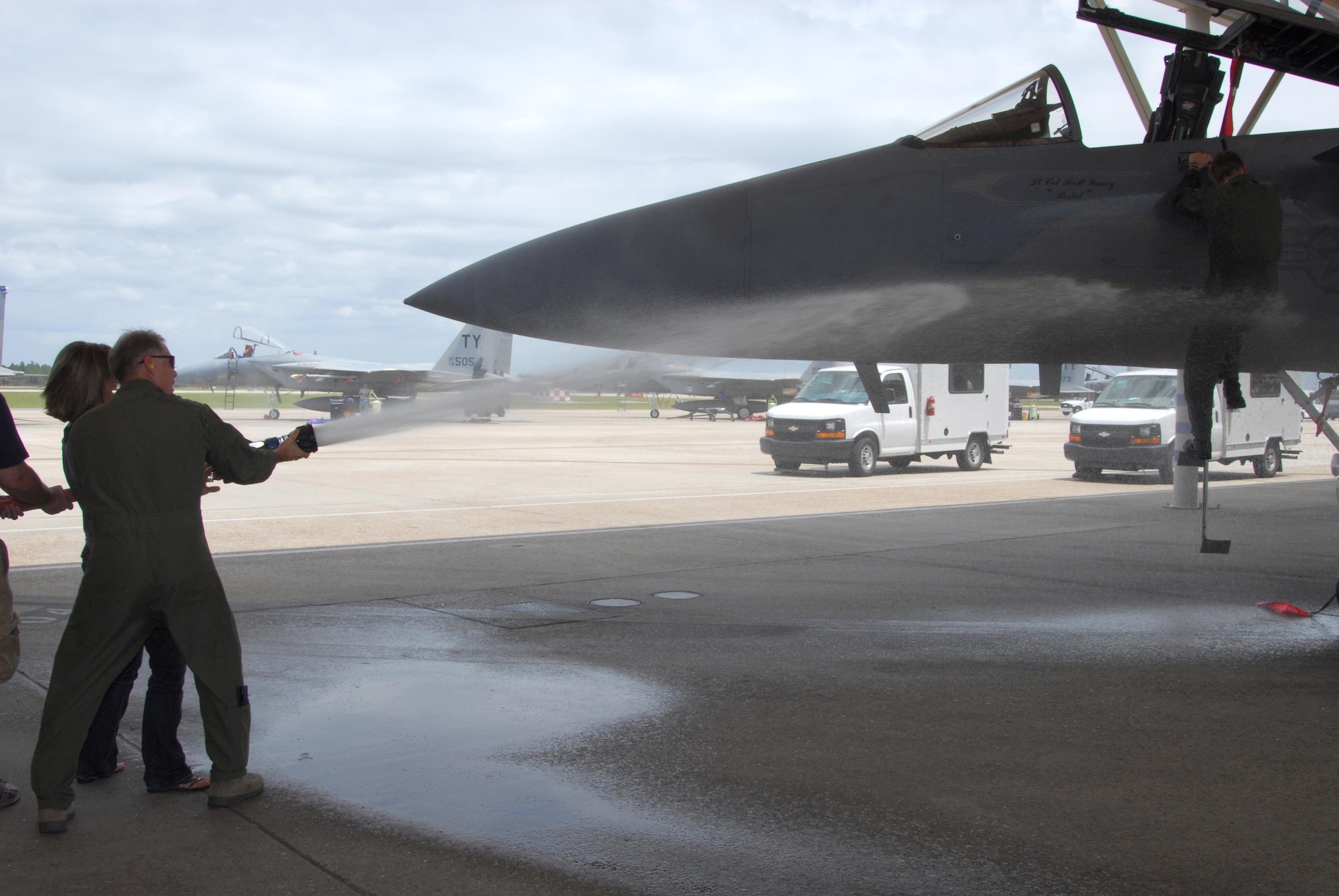 Col. Randy Spear, 601st Air and Space Operations Center vice commander, is hosed down by family, friends and the AOC commander, Col. David Kriner, as he lands his F-15 on his "Fini Flight." (Air Force Photo by: Ms. Lisa Norman)