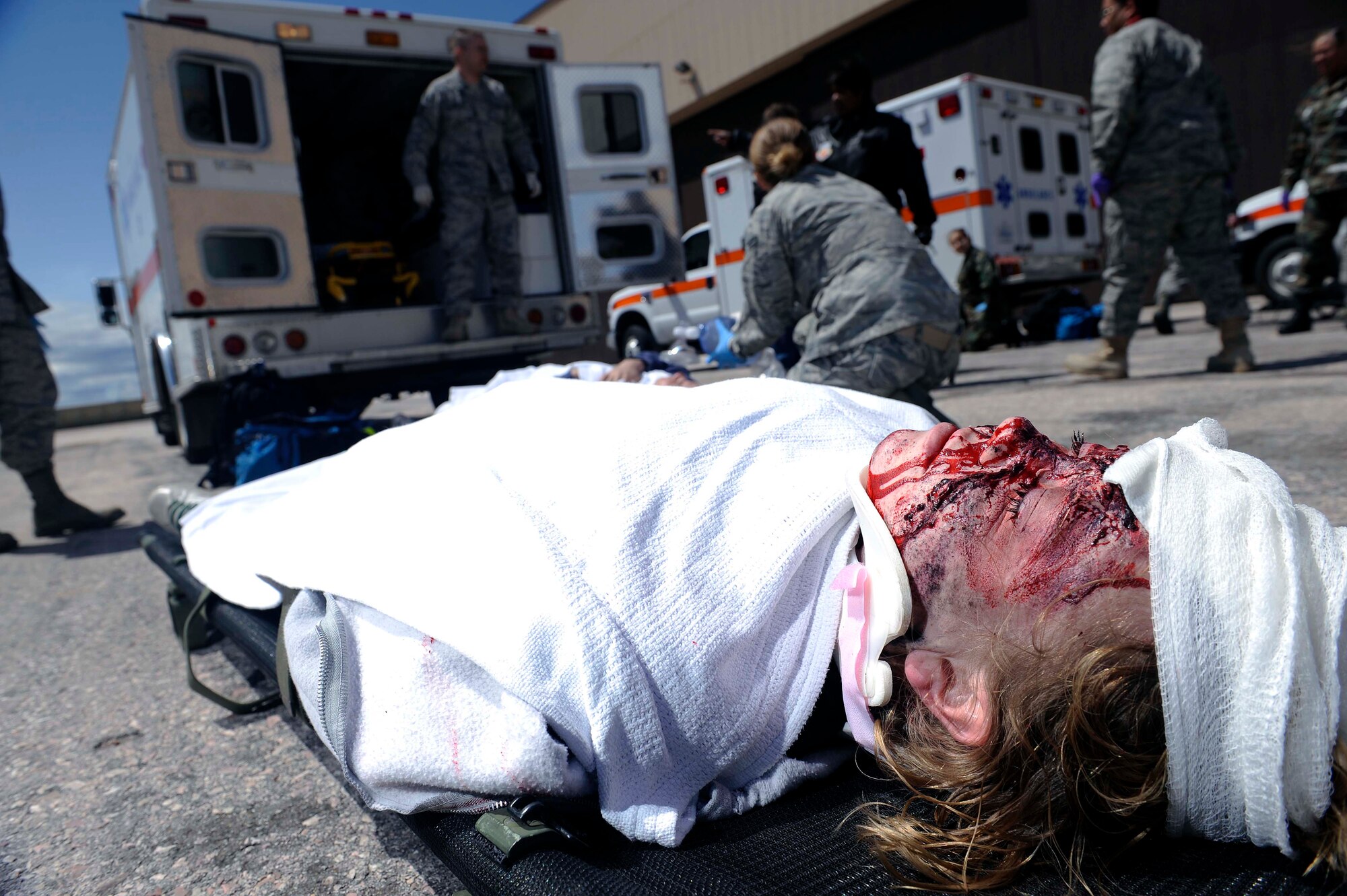 Emily Stevens, Western Dakota Technology College nurse student, participates as a simulated role-player during a major accident response exercise here, April 30.  A combined 22 members from Ellsworth Air Force Base and Western Dakota Technology College participated as role-players in the exercise. (U.S. Air Force photo by Airman 1st Class Corey Hook)