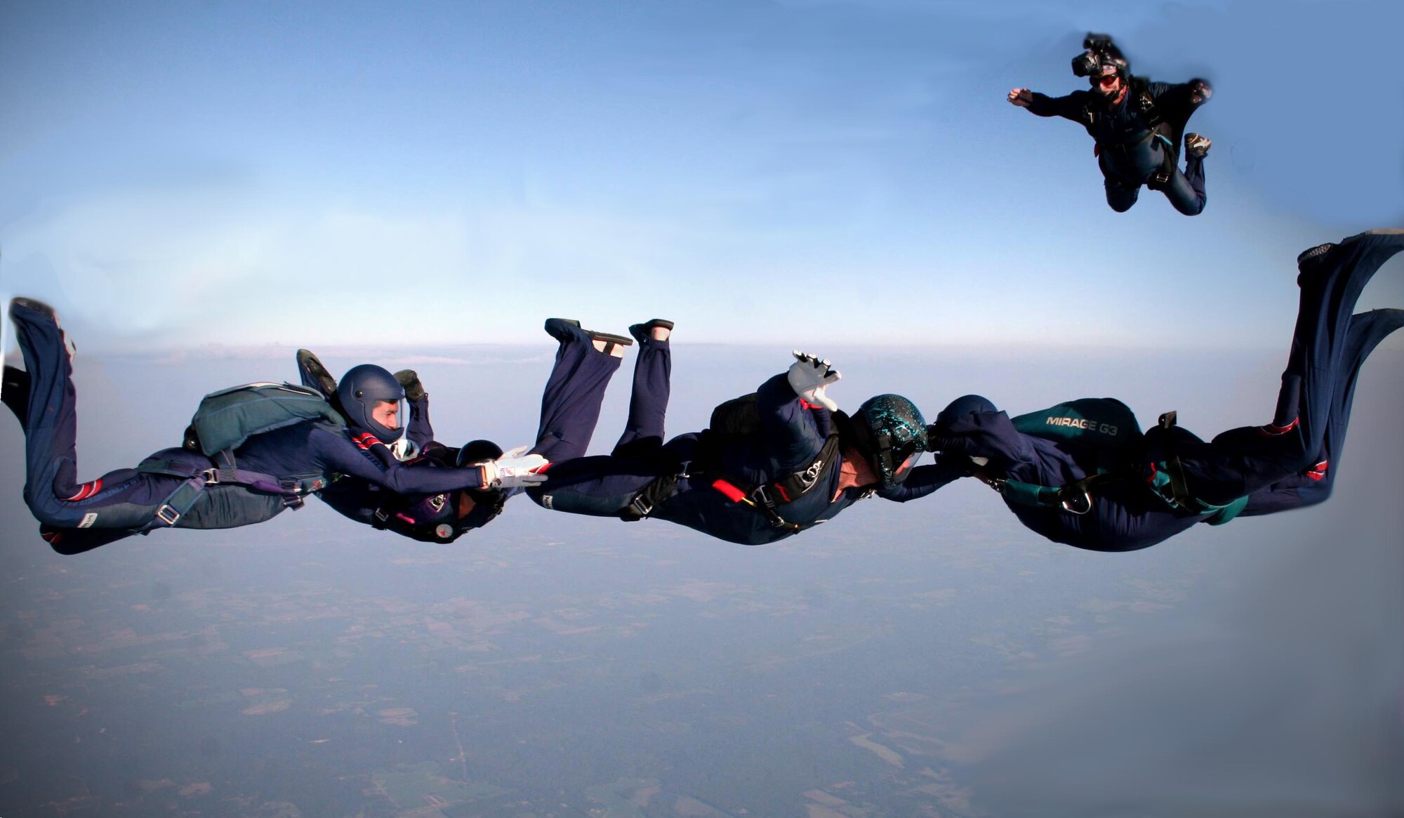 Staff Sgt. Victor Myrick films a formation skydiving team called MP4 at a competition in Atlanta, Ga. Sergeant Myrick is part of the 41st Aerial Port Squadron, Keesler Air Force Base, Miss., and is a licensed master skydiver. When skydiving, his job is to keep all members of the team in the video screen of his camera so they don't lose points. (Courtesy photo)