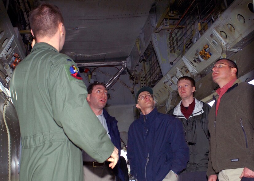 MINOT AIR FORCE BASE, N.D. -- 1st Lt. Matthew Middlebrooks, 23rd Bomb Squadron B-52H Stratofortress navigator, discusses the intricacies of the weapons compartment inside the B-52 with analysts of the National Geospatial Intelligence Agency during their tour here May 4.  The NGA visited the base to help familiarize themselves with the day-to-day operations of a bomber base and its personnel. (U.S. Air Force photo by Staff Sgt. Keith Ballard)