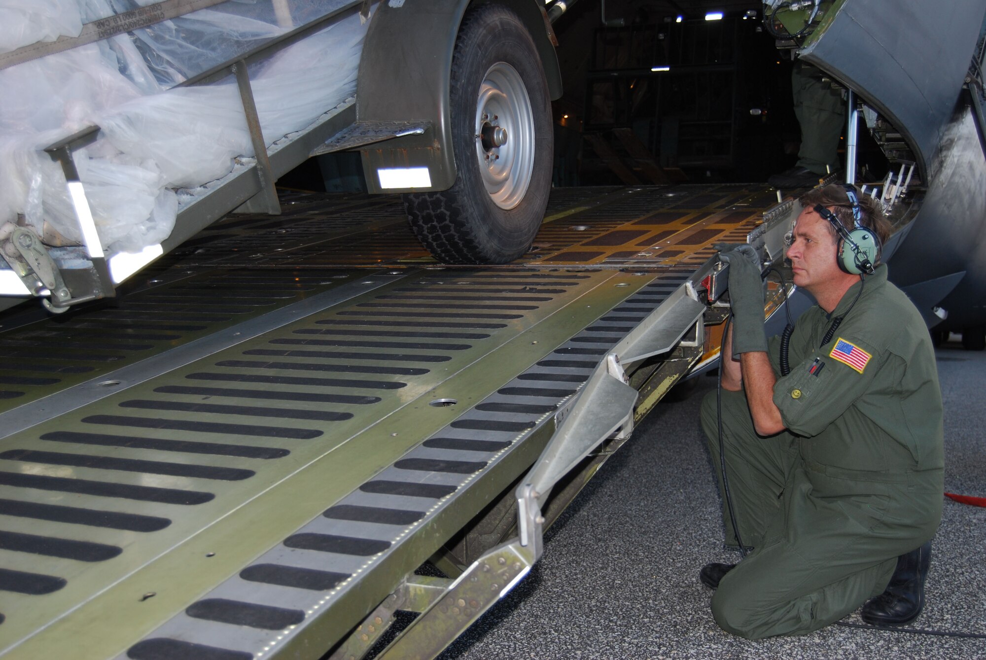 Master Sgt. Leroy Shaw, a flight engineer with the 68th Airlift Squadron, watches a vehicle being offloaded from a 433rd Airlift Wing C-5A at Rafeal Hernandez Airport in Aguadilla, Puerto Rico during excercise Patriot Hoover 2009. The vehicle from the 433rd Airlfit Contorl Flight is part of the equipment being used in affiliate training with the FBI and Puerto Rico Air National Guard. (U.S. Air Force Photo/Staff Sgt. Carlos Trevino)