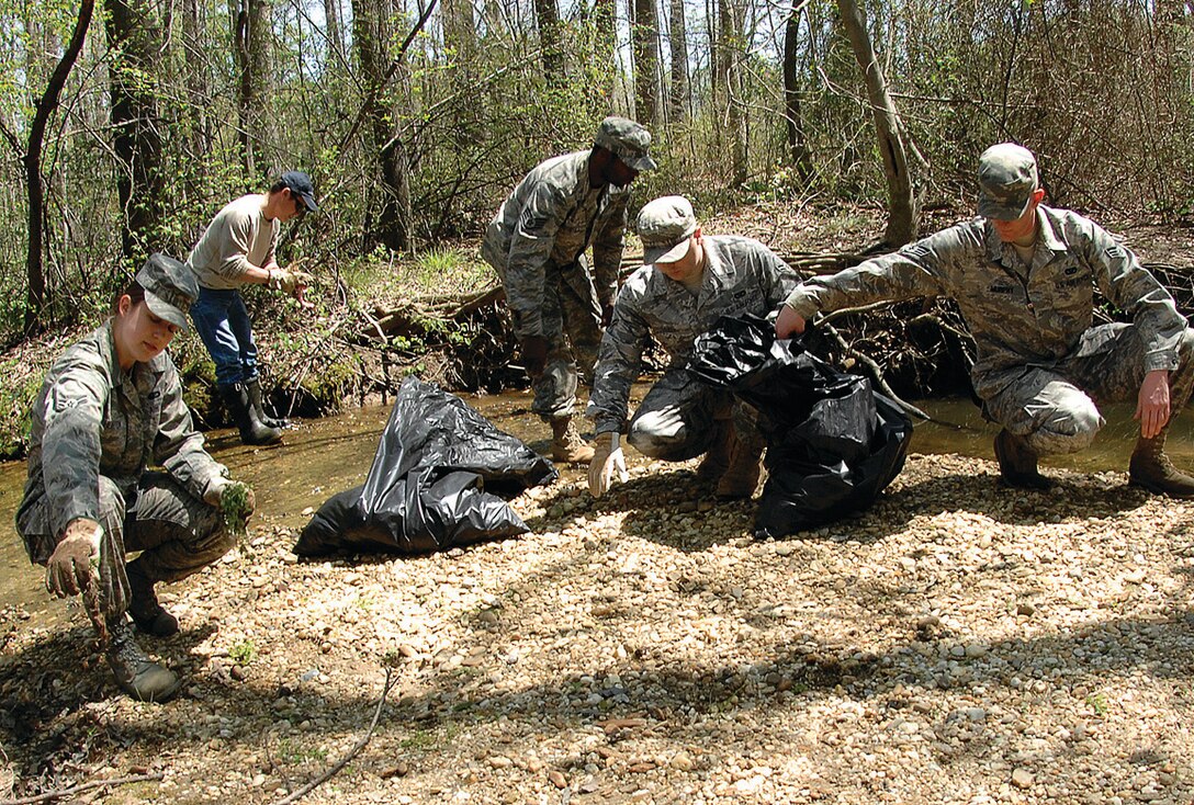 Airmen pick up debris near Tinkers Creek at Yuma Park during an Earth Day clean-up April 24. The base-wide cleanup and beautification focused on cleaning creeks, removing leaves and debris from gutters and planting flowers. Other initiatives focused on lawn care and maintaining shrubs. (U.S. Air Force photo/ Airman 1st Class Melissa Rodrigues)