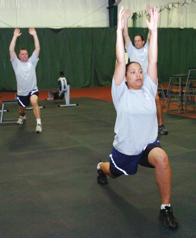 Joanna Mahner, 99 AS member, performs a power yoga stretch during a workout routine with fellow squadron members. (U.S. Air Force photo/ Bobby Jones)