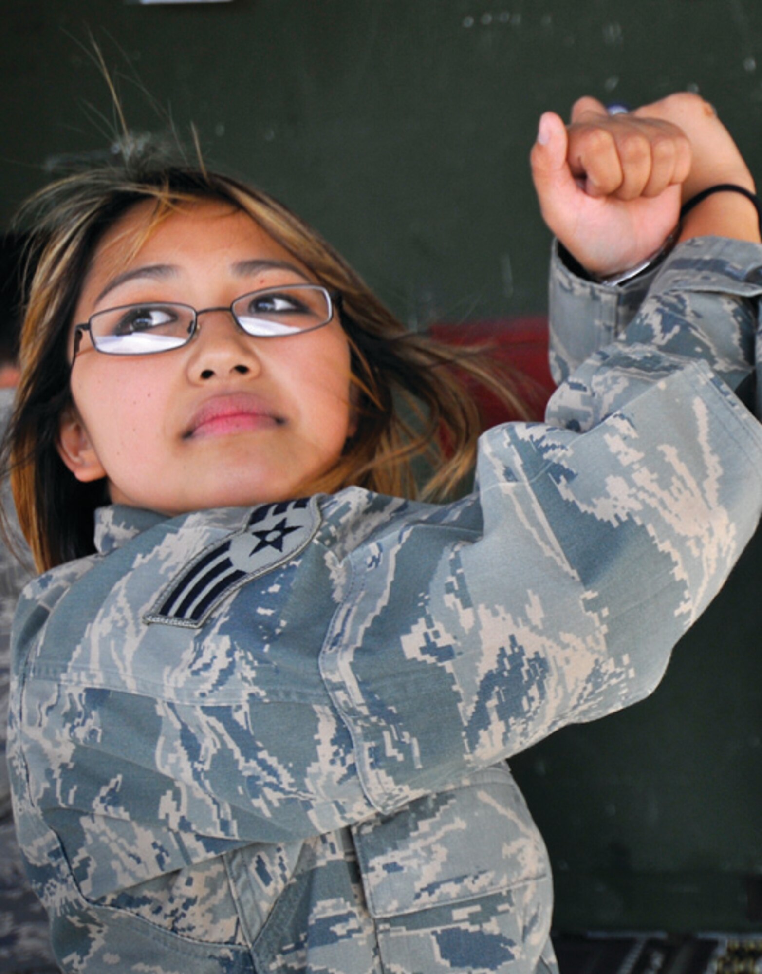 Senior Airman Miho Coggin, 779th Aeromedical Staging Facility medical technician, directs patient movement off a medical evacuation flight at Andrews. (U.S. Air Force photo/ Tech. Sgt. Suzanne M. Day)