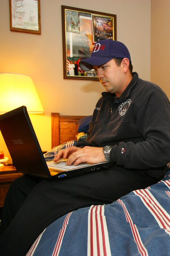 GRISSOM AIR RESERVE BASE, Ind.,  --  Captain Tim McMahon, firefighter, uses his computer to pass the time while working the evening shift at the Grissom fire house.  Firefighters work a shift of 48 hours on and 72 hours off and do a variety of activities to pass the time between emergency runs. (U. S. Air Force photo/Tech. Sgt. Patrick Kuminecz)