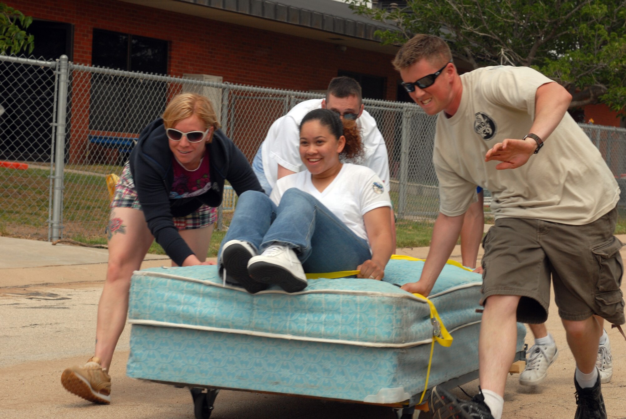 The 17th Security Forces Squadron bed race team races to the finish line during the Children's Festival April 25. (U.S. Air Force photo by Airman Clayton Lenhardt)