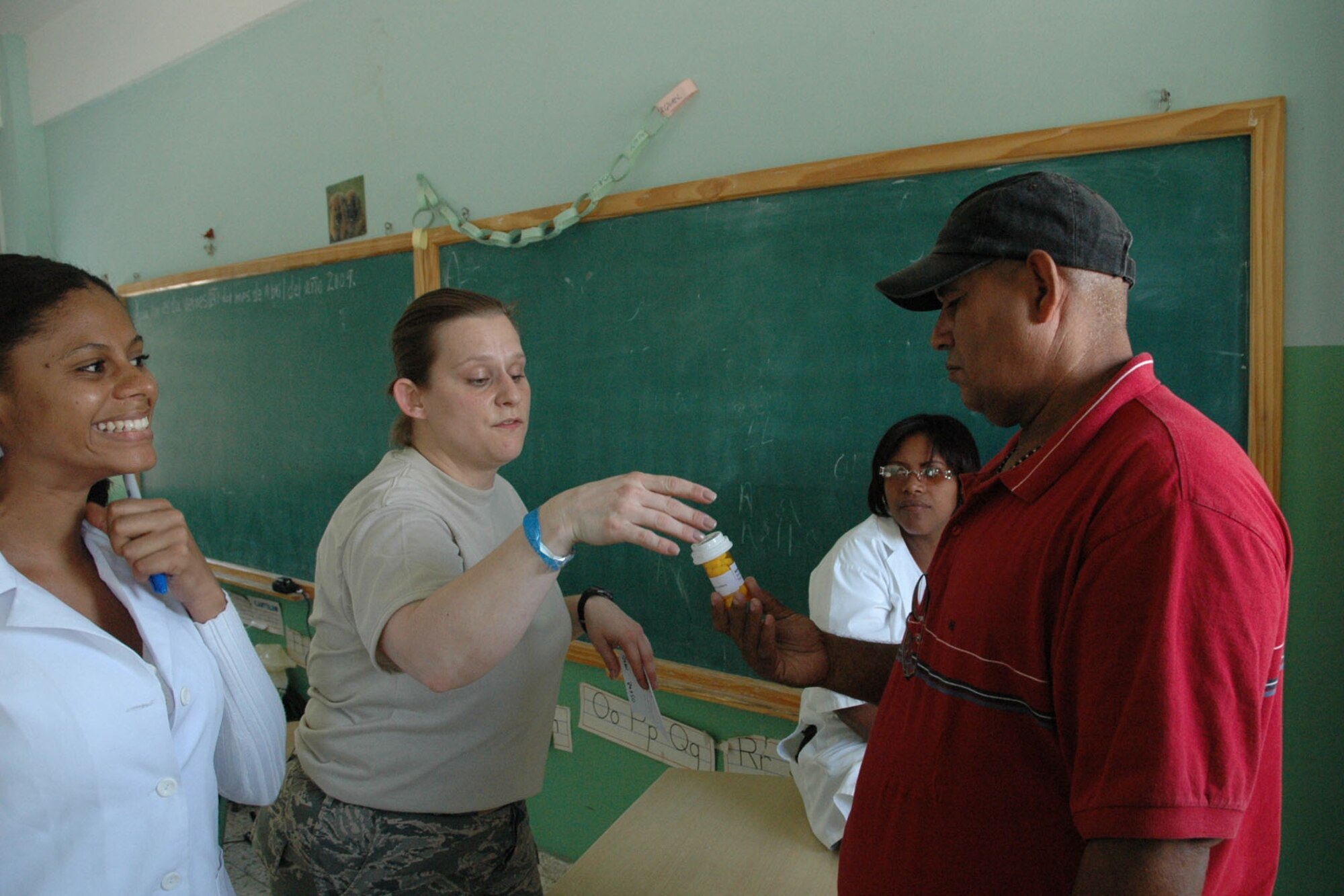 AZUA, Dominican Republic - U.S. Air Force Reservist Tech. Sgt. Danielle Forkapa hands a prescription to a Dominican resident here in the Pharmacy section of Dominican Republic Medical Readiness Training Exercise (MEDRETE). Sergeant Forkapa was among a team of more then 30 Citizen Airman providing much needed medical care to more than 10,000 Dominican residents during this mission, which kicked off on April 25 and is scheduled to last until May 8. (U.S. Air Force photo by Tech. Sgt. Bob Barko Jr.)