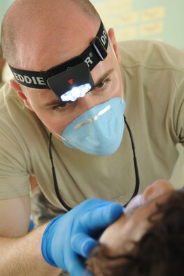 AZUA, Dominican Republic — U.S. Air Force Reserve Capt. Nicholas Duvall, assigned to the 910th Medical Squadron, extracts a tooth from a patient in the Dental Care section of Dominican Republic Medical Readiness Training Exercise (MEDRETE) 2009 here. Capt. Duvall is among a team of more than 30 Citizen Airman providing much needed medical care to more than 10,000 Domincan residents during this mission. The group left Youngstown Air Reserve Station, Ohio, April 26 and is scheduled to return May 8. U.S. Air Force photo by Senior Airman Clinton Kline.