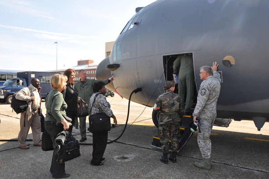 Senior Master Sgts. Ken Stacey, a 711th Special Operations Squadron loadmaster (pictured in front of aircraft nose) and Randy Usher, 919th Maintenance Squadron, (far right) stand by to assist Team Eglin members as they board a 919th Special Operations Wing MC-130E Combat Talon I at Eglin Air Force Base recently.  The 919th SOW provided airlift to and from Fort Bragg, N.C., for about 30 Eglin officials who spent two days briefing 7th Special Forces Group (Airborne) Soldiers and spouses about living and working at their future post near Duke Field. (U.S. Air Force photo/Master Sgt. Andrew Leonhard)