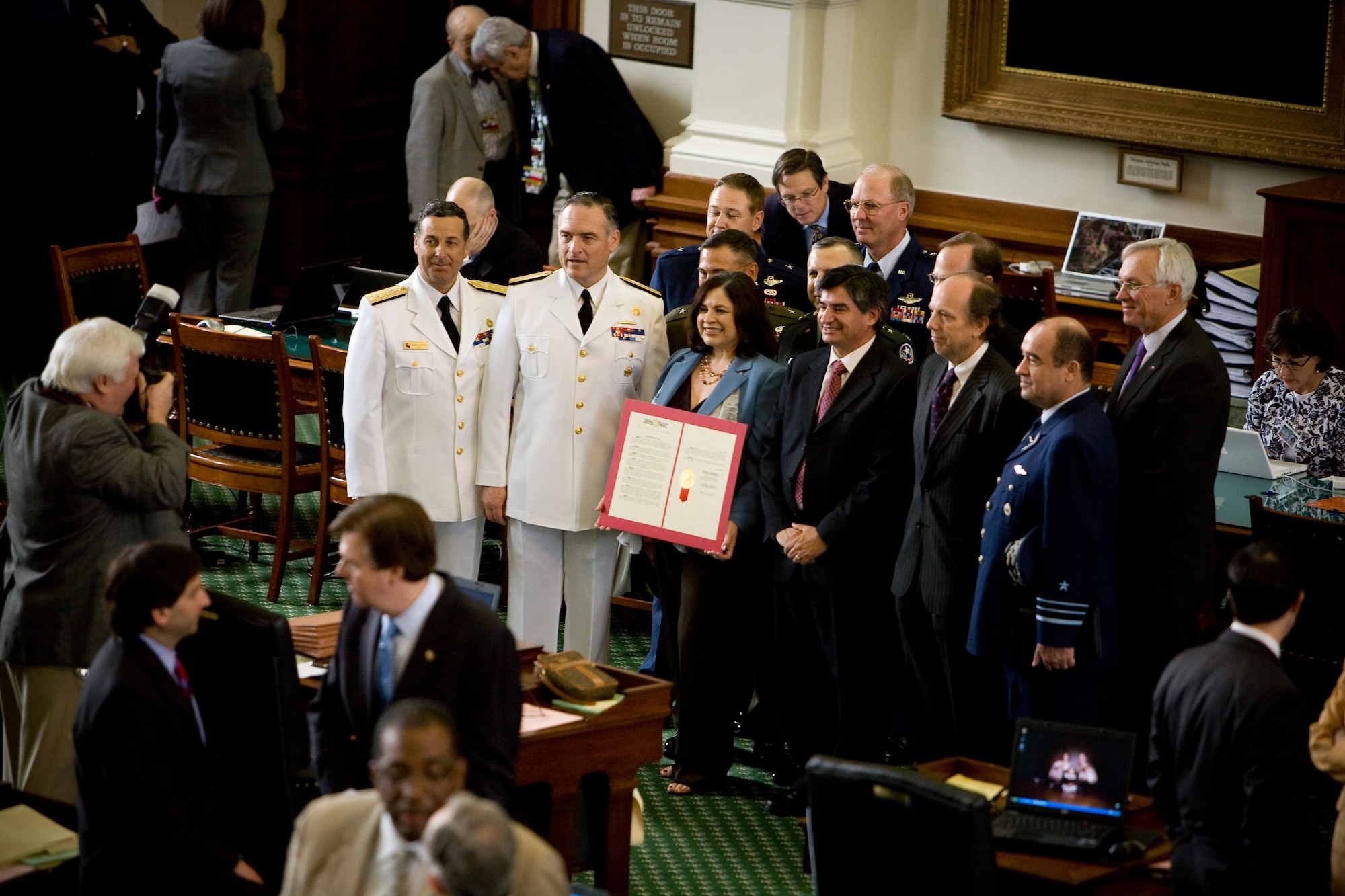 AUSTIN, Texas -- Chilean Delegation stand for a photo on the senate floor with Texas Senator Leticia Van de Putte, who minutes before presented the delegation with a Proclamation declaring a military partnership between Chile and Texas.  (Air National Guard photo by Staff Sgt. Eric Wilson)