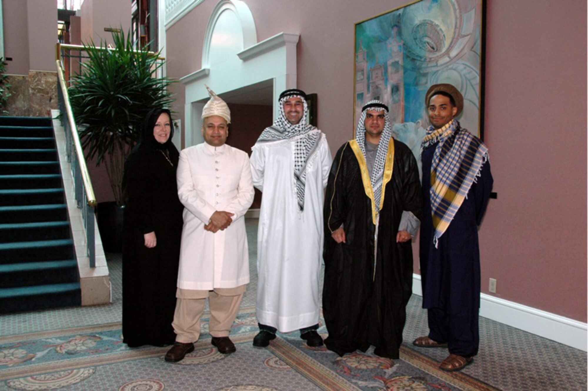 Trainers from the Current Operating Enviroment, Culture and Cross Cultural Competencies Workshop at the 2009 National Guard Diversity Conference pose in native dress.  The workshop emphasized a better understanding of middle eastern culture and diversity. (l to r) Ms. Ann O'Connor, Trainer, MSG Mahmood Qadri, AR-ARNG, SGT Michael Turk, TX-ARNG, 2Lt Haidar Hamoud, NE-ARNG, 2Lt Rafael Lantigua, Jr., NE-ARNG (Photo by MSgt. Mary-Dale Amison)