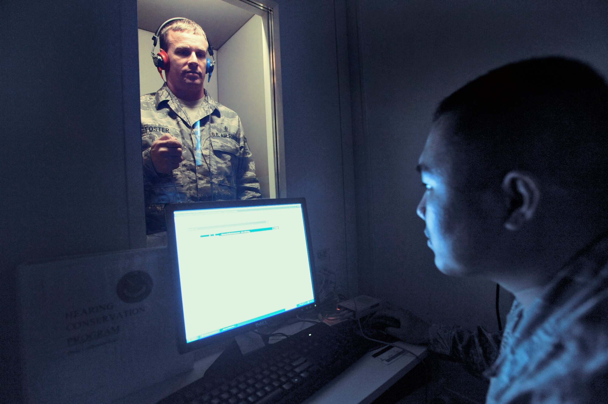 Tech. Sgt. Duwayne Foster and Staff Sgt. Rommel Hernandez run an operations check on the new hearing test booth April 30 at an air base in Southwest Asia. The base is the first in the U.S. Central Command's area of responsibility to have a hearing test booth. Sergeant Foster is the NCO in charge of public health for the 379th Expeditionary Medical Group, and is a native of Mobile, Ala. Sergeant Hernandez is the assistant NCO in charge of public health and hails from Arlington, Va. Both are deployed from Keesler Air Force Base, Miss. (U.S. Air Force photo/Staff Sgt. Joshua Garcia) 
