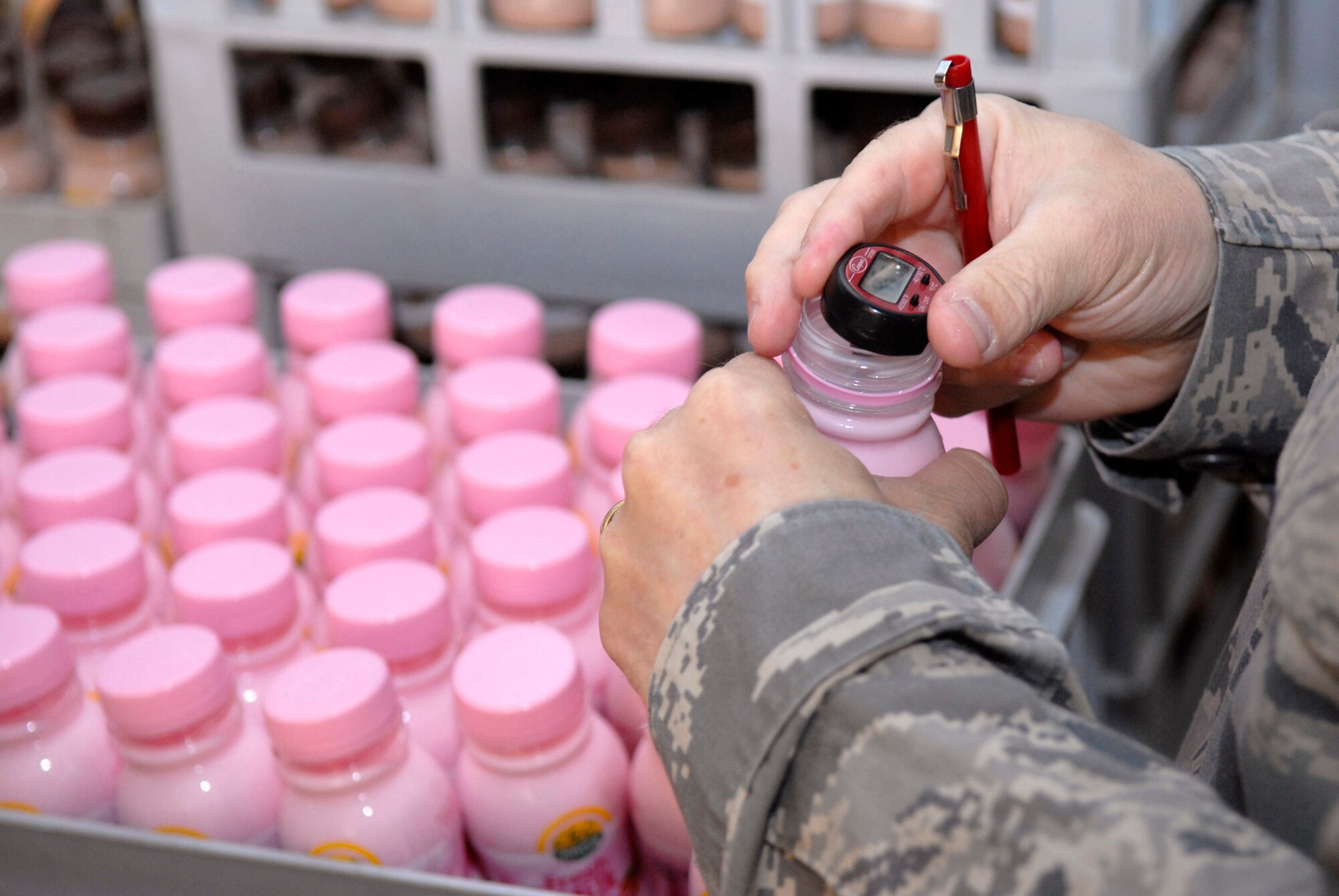 Tech. Sgt. Duwayne Foster takes the temperature of a bottle of milk to ensure it is properly refrigerated during the monthly dining facility inspection April 18 at an air base in Southwest Asia. The public health office inspects the dining facilities, checks personnel medical records, and provides medical intelligence for forward deployers. Sergeant Foster is the 379th Expeditionary Medical Group NCO in charge of public health and hails from Mobile, Ala. He is deployed from Keesler Air Force Base, Miss. (U.S. Air Force photo/Senior Airman Andrew Satran) 
