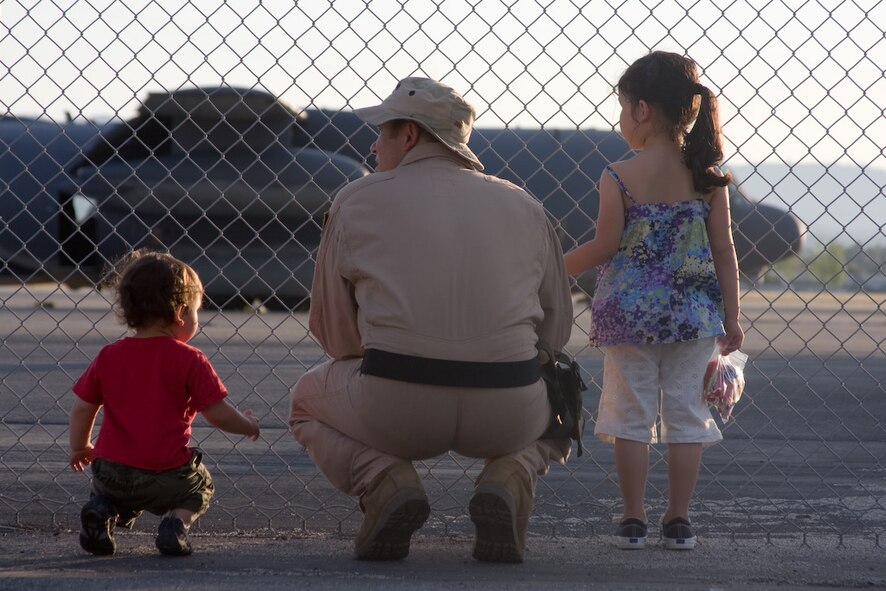 Master Sgt. Miguel Toro, 130th Rescue Squadron loadmaster, spends time with his children before his deployment to the Horn of Africa. Thirty Airmen from the 129th Rescue Wing departed on two MC-130P Combat Shadow aircraft for a 40-day deployment to Djibouti, Africa, April 21, 2009. (Photo courtesy of Mr. Sagar Pathak, www.horizontalrain.com)