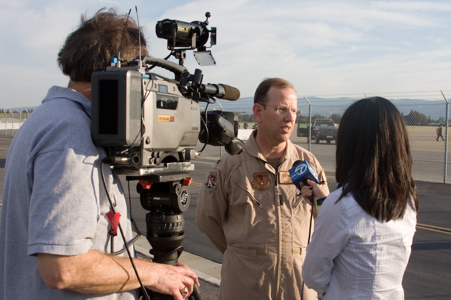Colonel Mark Sheehy, 129th Operations Group commander, interviews with a local television news reporter before his deployment to the Horn of Africa. Thirty Airmen from the 129th Rescue Wing departed on two MC-130P Combat Shadow aircraft for a 40-day deployment to Djibouti, Africa, April 21, 2009. (Photo courtesy of Mr. Sagar Pathak, www.horizontalrain.com)