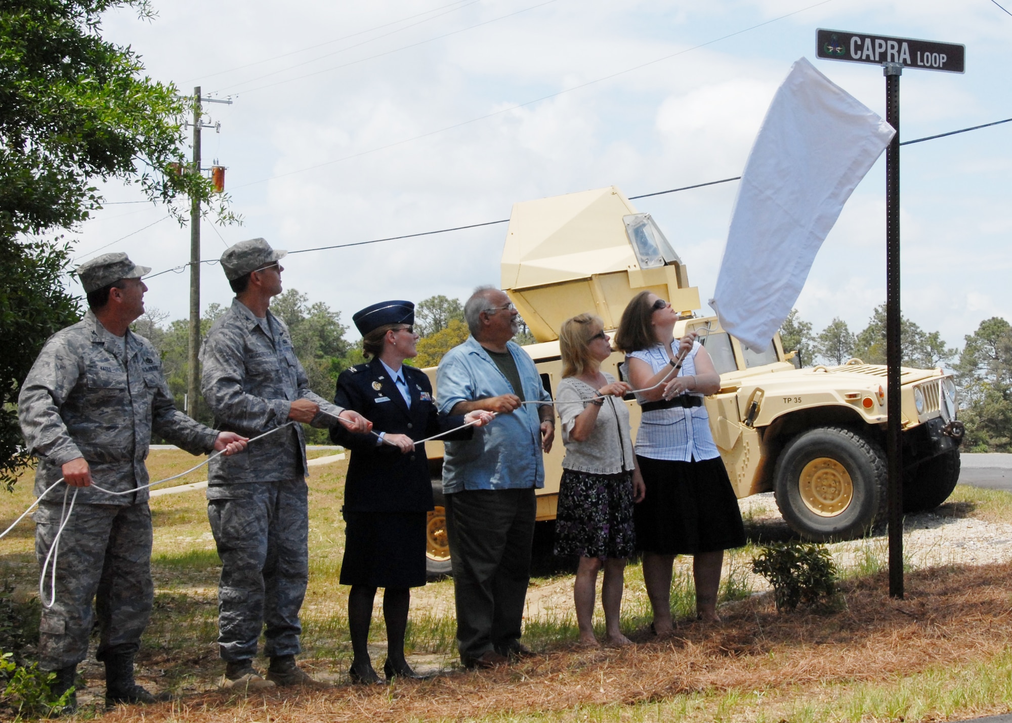 Commanders and family members reveal the newest Eglin street sign May 1, honoring a fallen Explosive Ordnance Disposal Airman and former Team Eglin member.  The street named after Tech. Sgt. Anthony Capra makes a loop around the new EOD facility.  Sergeant Capra died in Iraq in 2008.  (From left to right)  Col. Dennis Yates, 96th Civil Engineer Group commander, Col. Bruce McClintock, 96th Air Base Wing commander, Col. Michelle Miller-Peck, 308th Armament Systems Wing commander, Anthony Capra Sr., Sharon Capra and Angie Capra.  U.S. Air Force photo/Samuel King Jr.