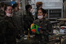 SEYMOUR JOHNSON AIR FORCE BASE, N.C. -- Reservists from the 916th Aerospace Medicine Flight dawn their protective masks during the 916th Combat Dining In.