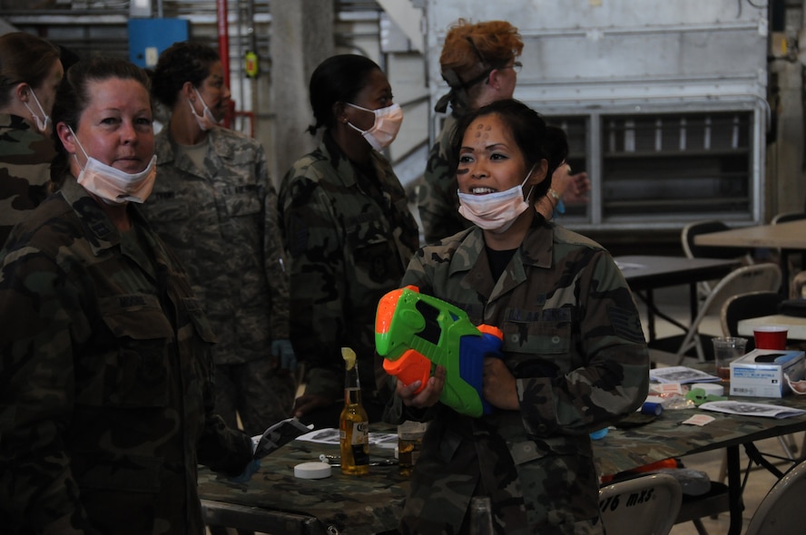 SEYMOUR JOHNSON AIR FORCE BASE, N.C. -- Reservists from the 916th Aerospace Medicine Flight dawn their protective masks during the 916th Combat Dining In.