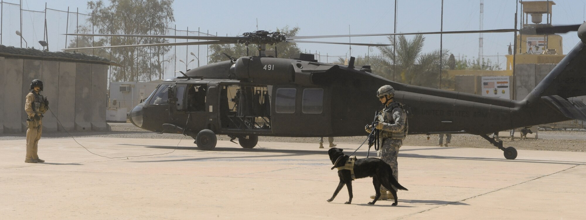 Senior Airman Ted Carlson egresses a helicopter with his military working dog, Dutchy, during training April 21 at Joint Base Balad, Iraq. The training teaches the team how to safely and properly enter and exit aircraft, and prepares them for future air-assault missions. Airman Carlson is a 332nd Security Forces Group military working dog handler deployed from Moody Air Force Base, Ga. He is a native of Rochester, N.Y. (U.S. Air Force photo/Senior Airman Elizabeth Rissmiller) 
