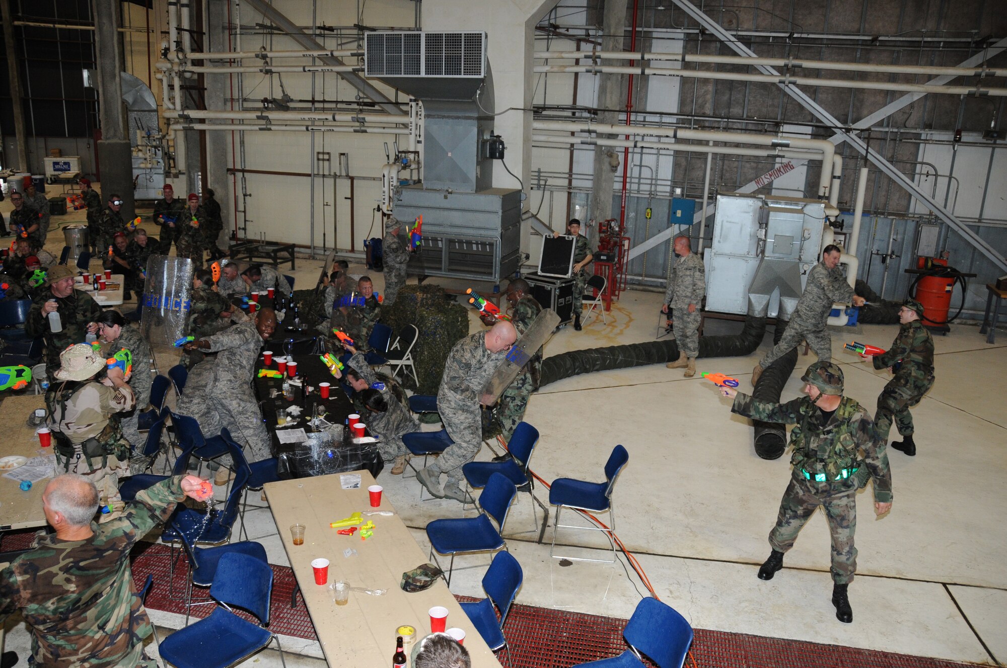 SEYMOUR JOHNSON AIR FORCE BASE, N.C. -- Reservists from the 916th Air Refueling Wing and active duty members for the 911th Air Refueling Squadron take part in a water fight during the combat dining in held during the May unit training weekend.
