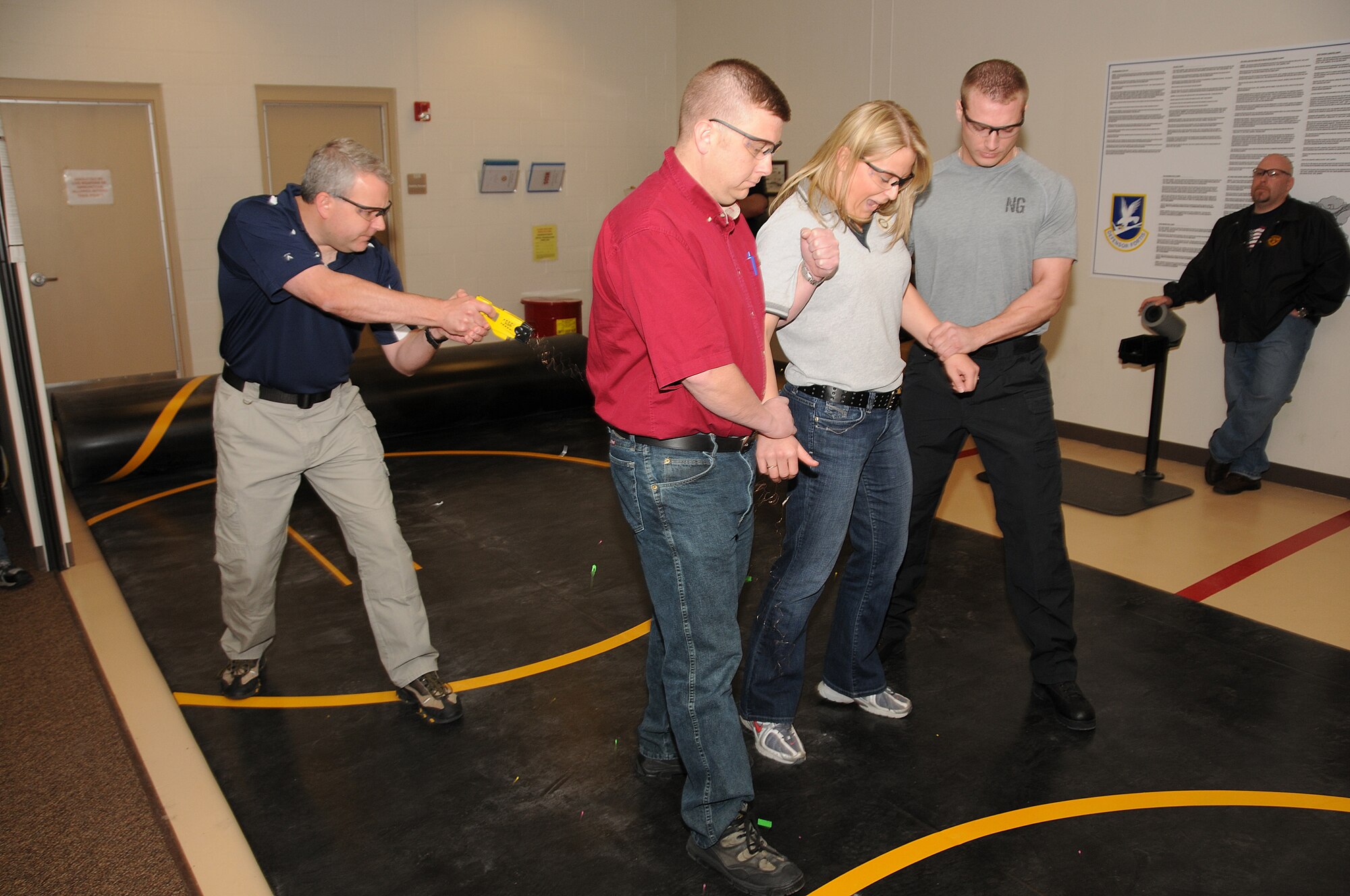 Chandler Garrett a Staff Master Instructor with Taser International demonstrates use of the Taser at a class held recently at the 185th Air Refueling Wing in Sioux City, Iowa.
 On the receiving end of the Taser is Staff Sergeant Sarah Hinrichs of the 185th ARW Security Sorces. 

USAF Photo by MSGT Vincent De Groot
185th ARW Public Affairs
