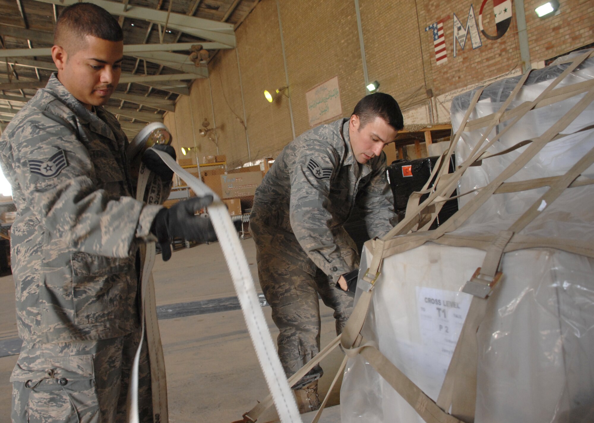 KIRKUK REGIONAL AIR BASE, Iraq – 506th Expeditionary Logistics Readiness Squadron aerial porters Staff Sergeants Daniel Tidings and Perry Simson build and secure a pallet of cargo before it’s loaded onto a departing aircraft here in March. Sergeant Tidings, a Sunrise, Fla., native, and Sergeant Simson, a Bradenton, Fla., native, are deployed from the 70th Aerial Port Squadron, Homestead Air Reserve Base, Fla. (U.S. Air Force photo by Senior Airman Jessica Lockoski)