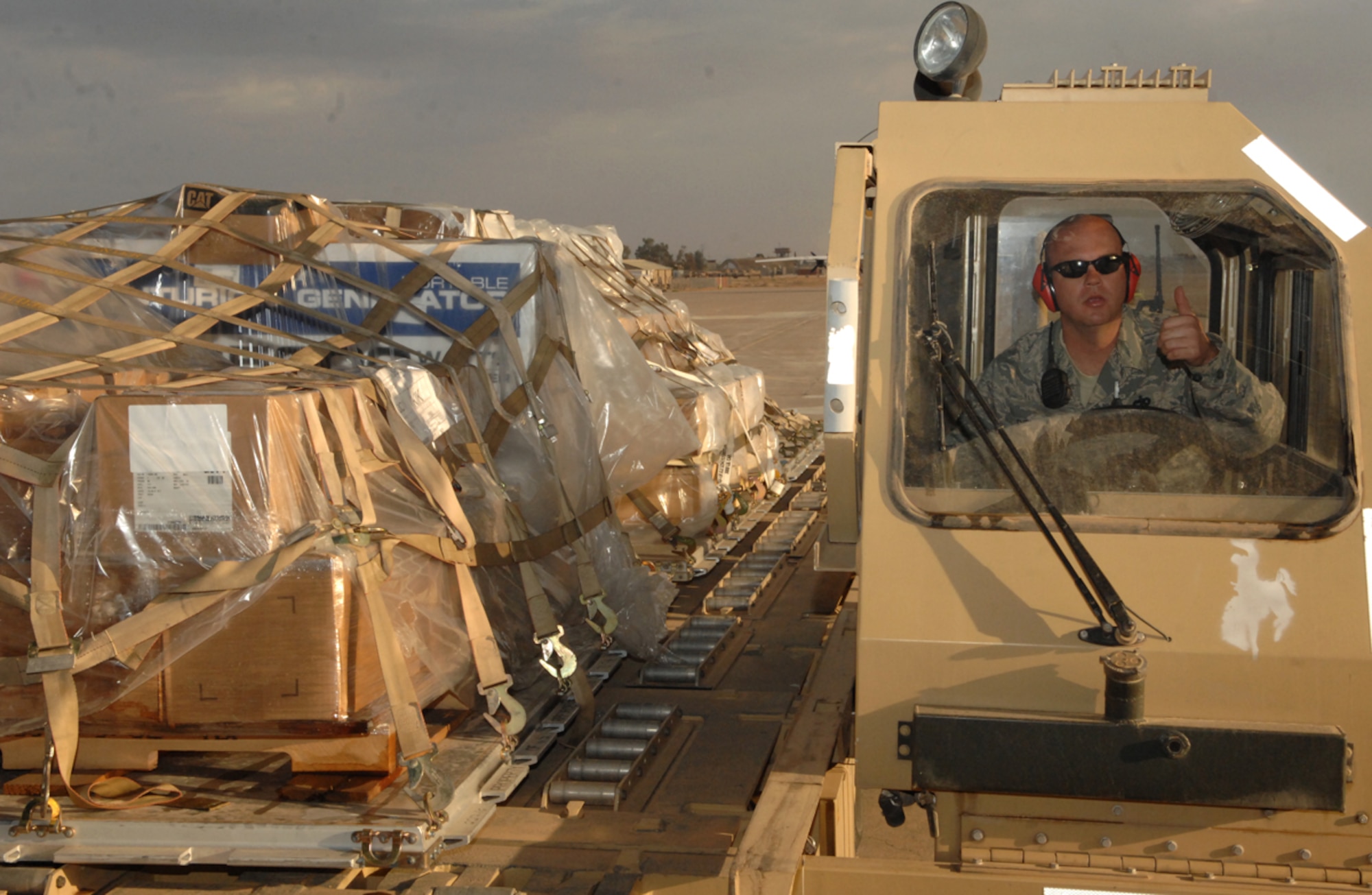 KIRKUK REGIONAL AIR BASE, Iraq -- Tech. Sgt. Chad Ehrlich, 506th Expeditionary Logistics Readiness Squadron, gives a thumbs-up to a loadmaster before loading cargo pallets on an Iraqi aircraft here in March. The Cocoa, Fla., native is a Reservist deployed from the 70th Aerial Port Squadron, Homestead Air Reserve Base, Fla. (U.S. photo by Senior Airman Jessica Lockoski)