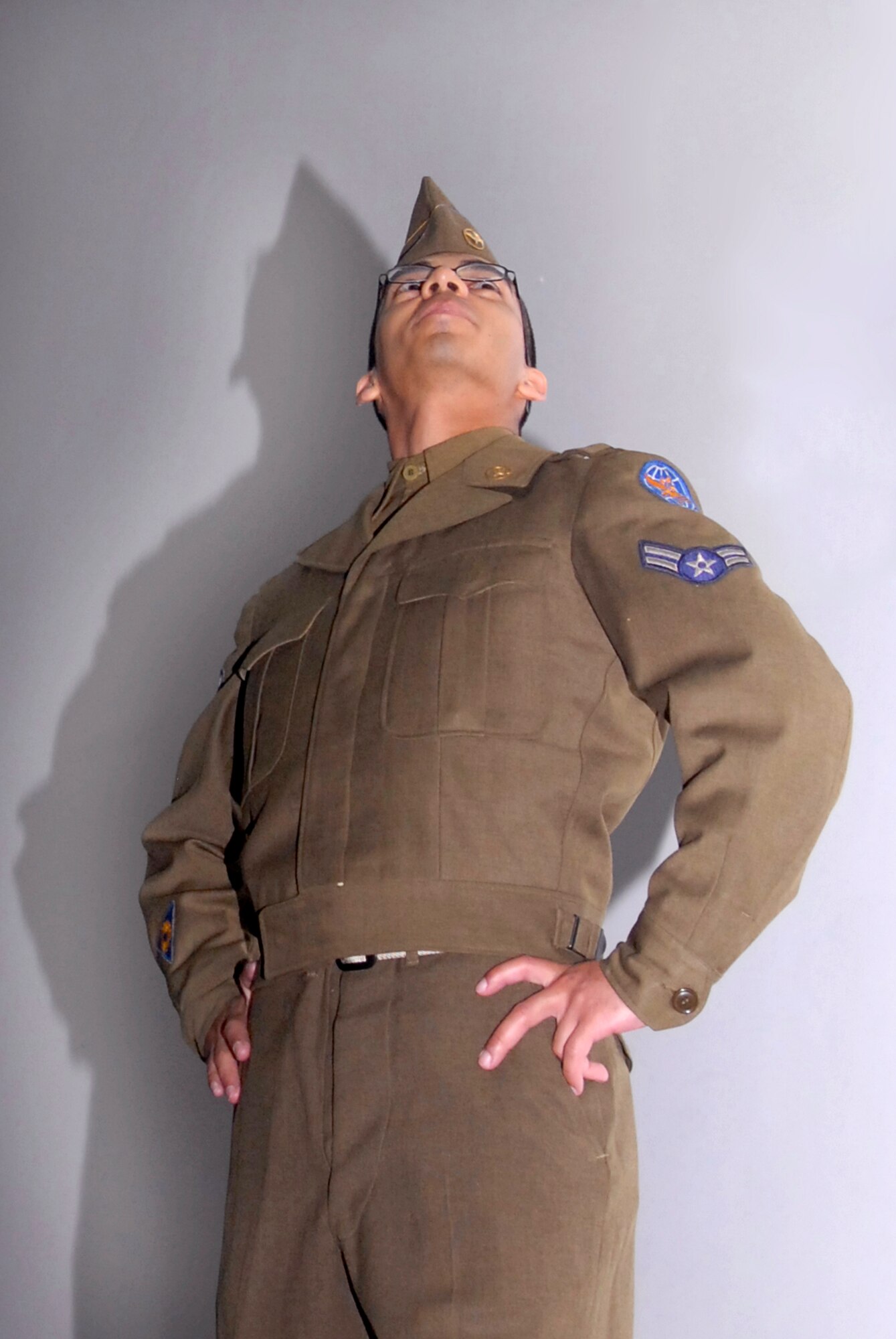 Senior Airman Eliezer Cruz-Flacon, 379th Expeditionary Communications Squadron, models the World War II Army Air Corps transitional uniform with Air Force accouterments during Operation Uniform Delta, April 27, 2009, at an undisclosed base in Southwest Asia.  Operation Uniform Delta was an event displaying the history and birth of the Air Force uniform and showed the transitions that it underwent through the years.  Airman Cruz-Falcon hails from Orlando, Fla. and is deployed from Ramstein Air Base, Germany in support of Operations Iraqi and Enduring Freedom and Combined Joint Task Force - Horn of Africa. (U.S. Air Force photo/Senior Airman Andrew Satran/released)